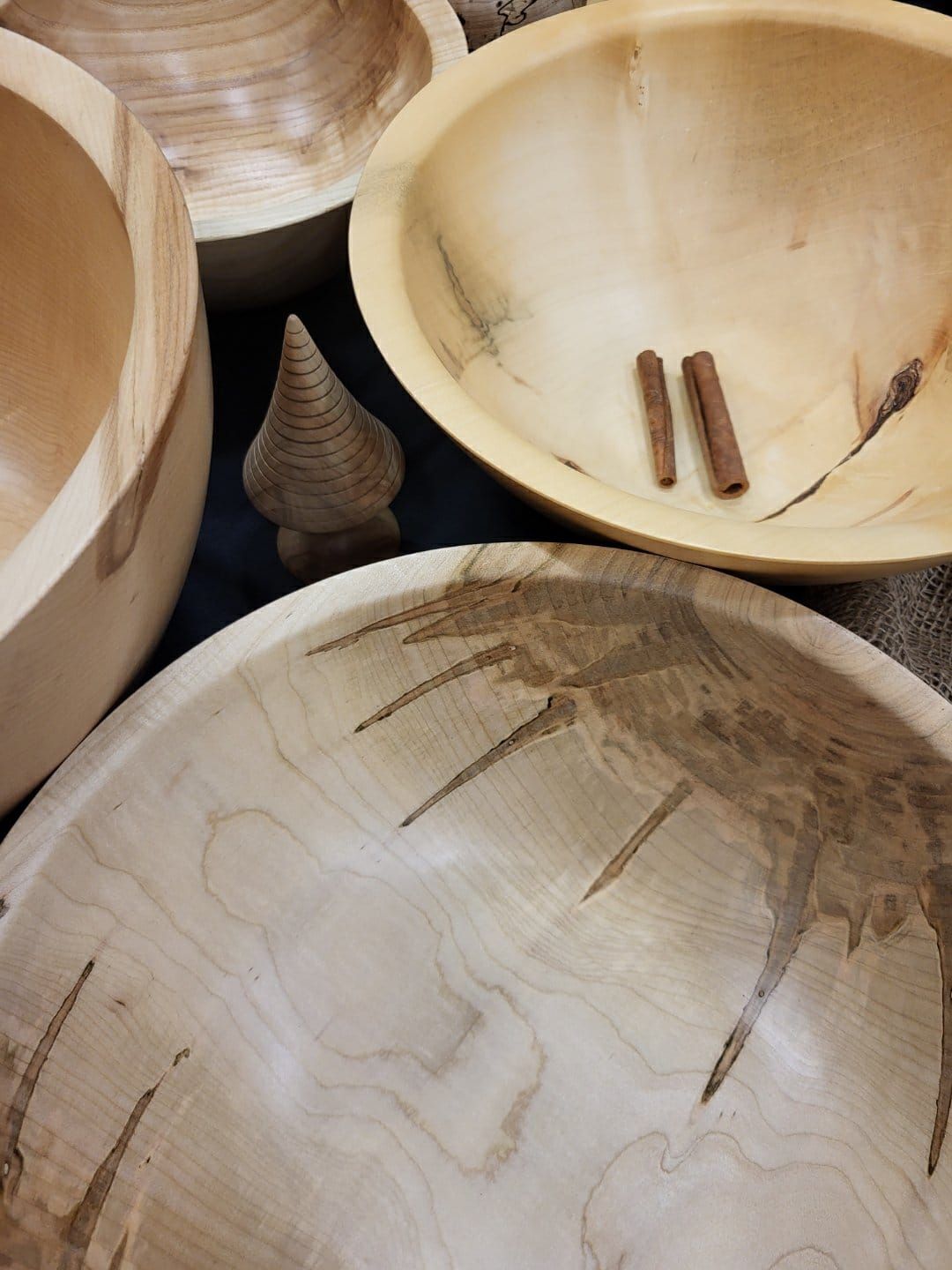 Hand-turned maple bowls with dark streaks in the grain