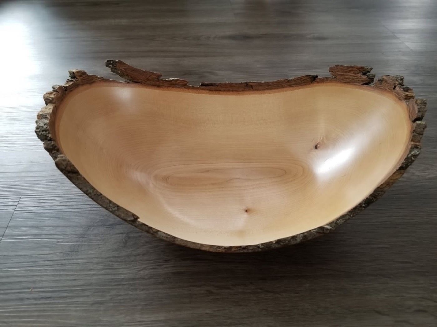 A live-edge bowl with bark left on the rim